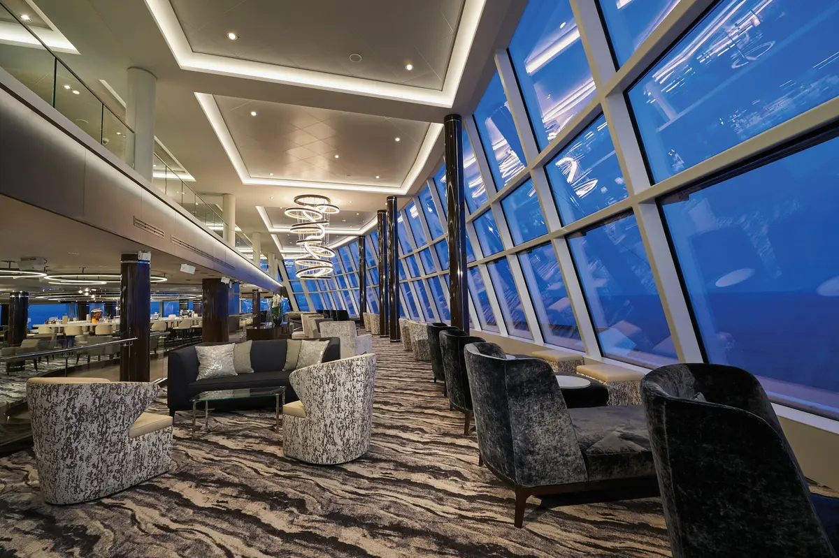 The Observation Lounge at dusk, deep blue sea through floor-to-ceiling windows